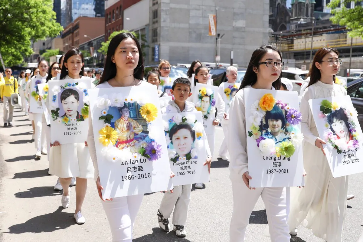 Falun Dafa practitioners carry placards bearing images of victims who died from persecution in China, during the World Falun Dafa Day parade in New York City on May 16, 2019. (Samira Bouaou/The Epoch Times)
