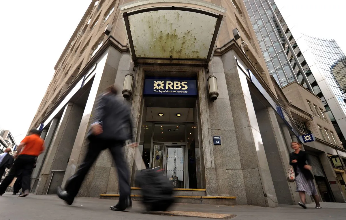People walk past a branch of the Royal Bank of Scotland (RBS),in London, on Aug. 4, 2010. (Ben Stansall/AFP/Getty Images)