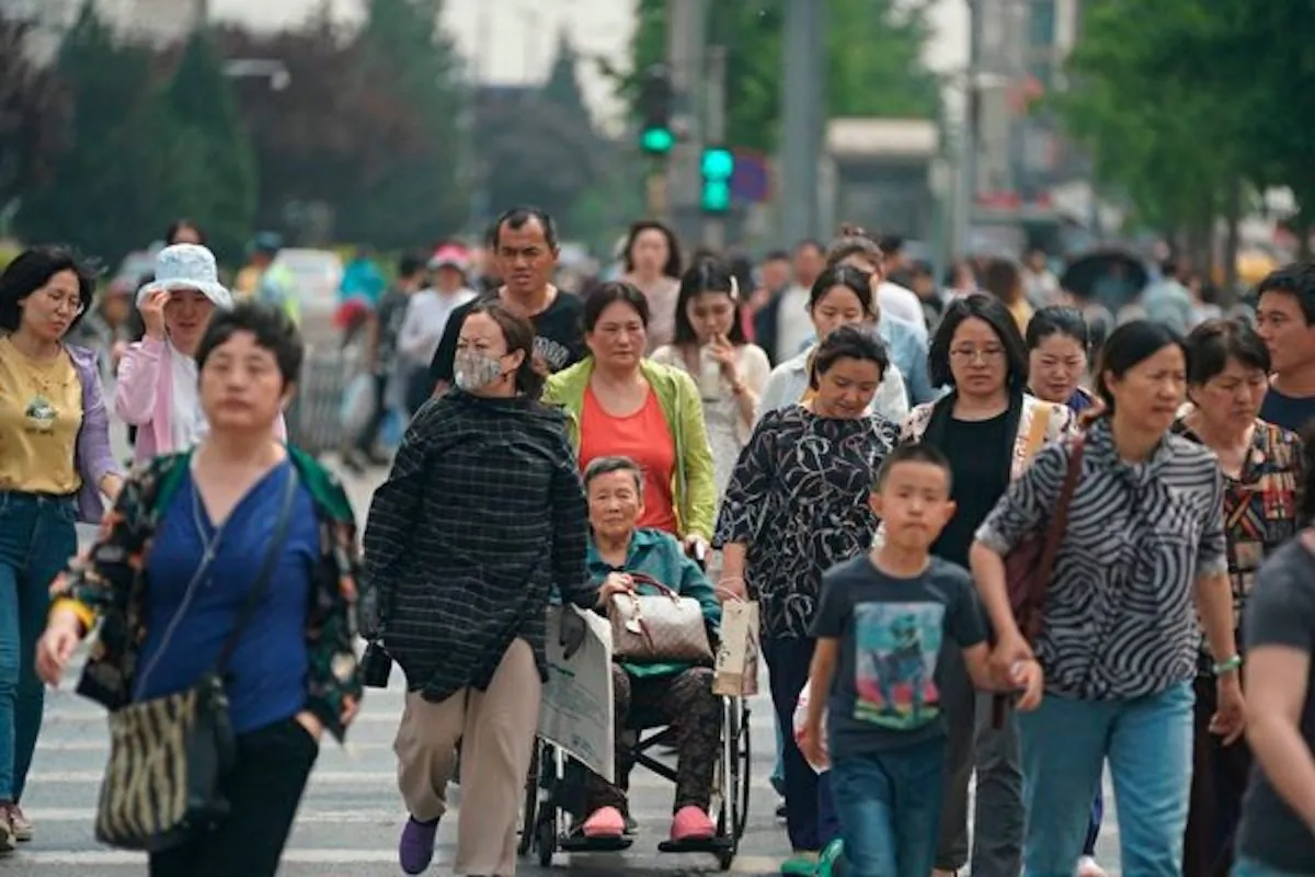 People cross a street in Beijing on May 10, 2019. Western pundits have been promoting a so-called "Chinese Century," which may never happen. (Fred Dufour/AFP/Getty Images)