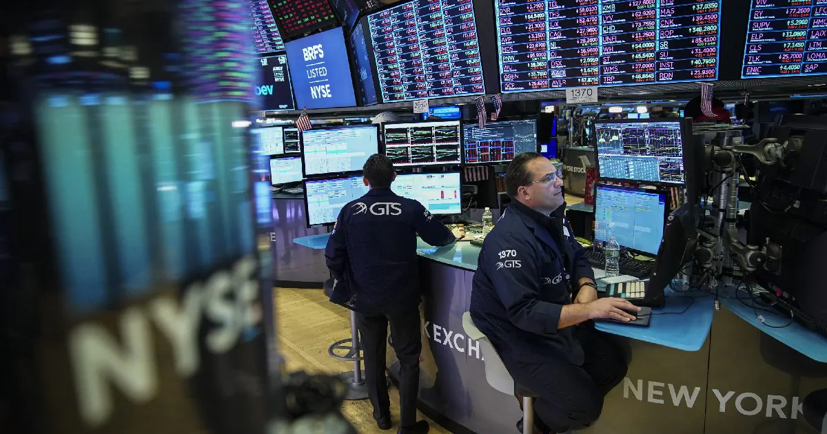 Traders and financial professionals work ahead of the closing bell on the floor of the New York Stock Exchange (NYSE) in New York City on May 13, 2019.