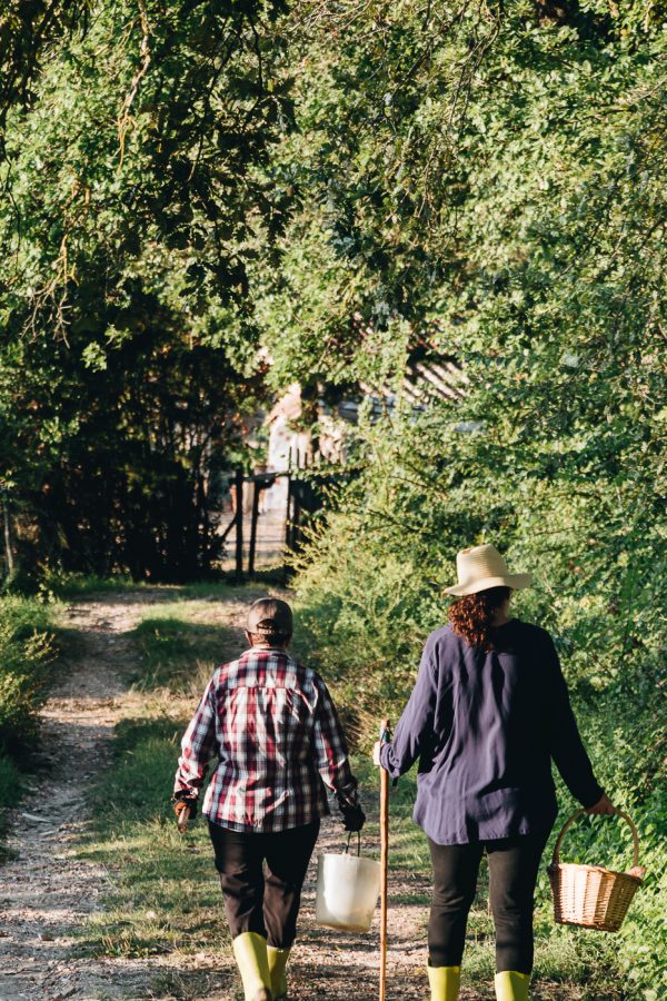 mother and daughter holding baskets for picking blackberries