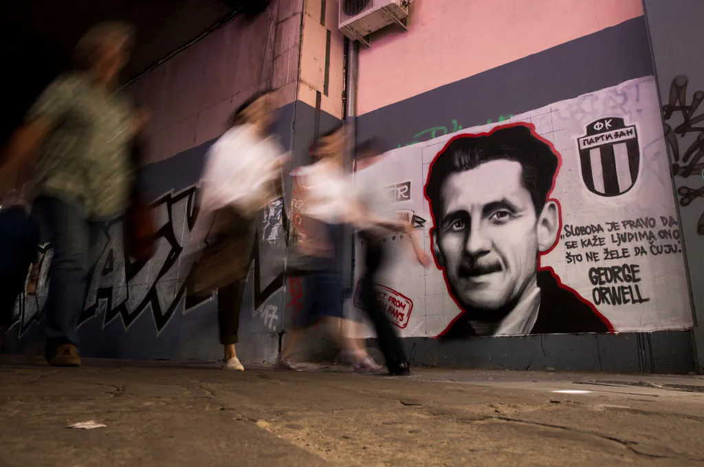 People walk past a mural depicting British novelist George Orwell with the reading "Freedom is the right to tell people what they do not want to hear," in Belgrade on May 8, 2018. (OLIVER BUNIC/AFP/Getty Images)