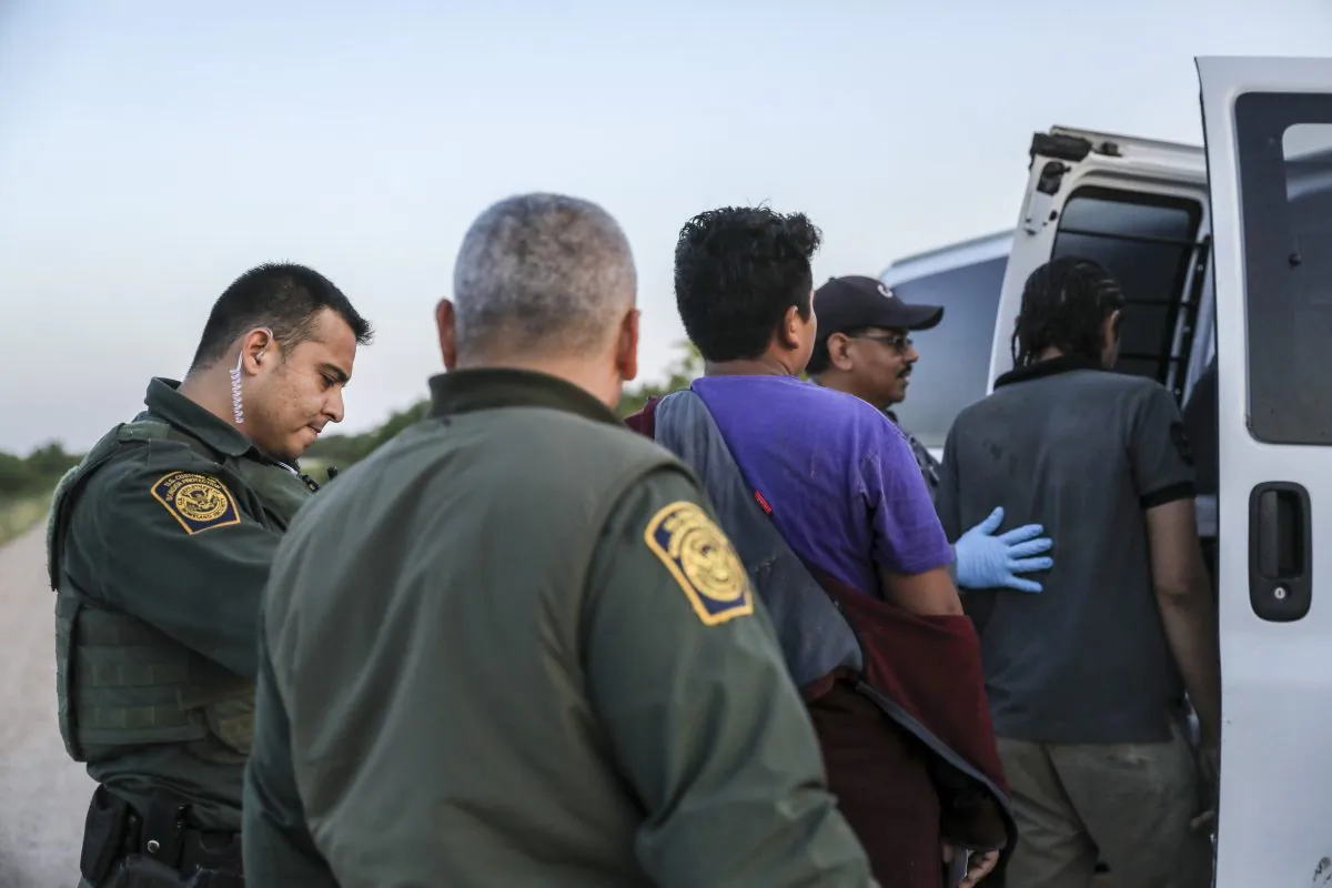 Border Patrol agents apprehend illegal immigrants who have just crossed the Rio Grande from Mexico into the United States near McAllen, Texas, on April 18, 2019. (Charlotte Cuthbertson/The Epoch Times)
