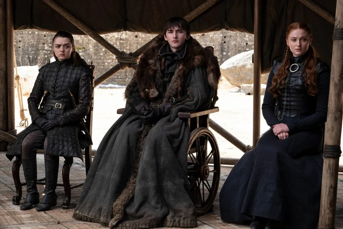 This image released by HBO shows from left to right Maisie Williams, Isaac Hempstead Wright and Sophie Turner in a scene from the final episode of "Game of Thrones," that aired on May 19, 2019. (HBO via AP)