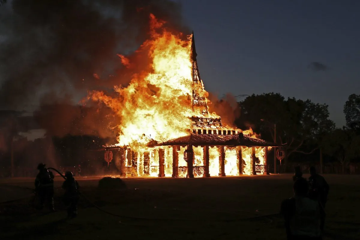 The "Temple of Time" built as a memorial to the 17 victims of a shooting at Marjory Stoneman Douglas High School is seen on fire during a ceremonial burning in Coral Springs, Fla., on May 19, 2019. (John McCall/South Florida Sun-Sentinel via AP)