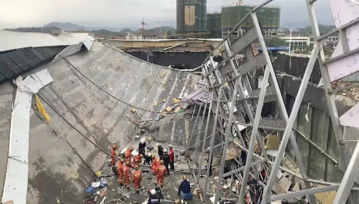 In this image from video, rescuers try to find survivors at the site where a building collapsed in Baise City, Guangxi Zhuang Autonomous Region, south China on May 20, 2019. (CCTV via AP)