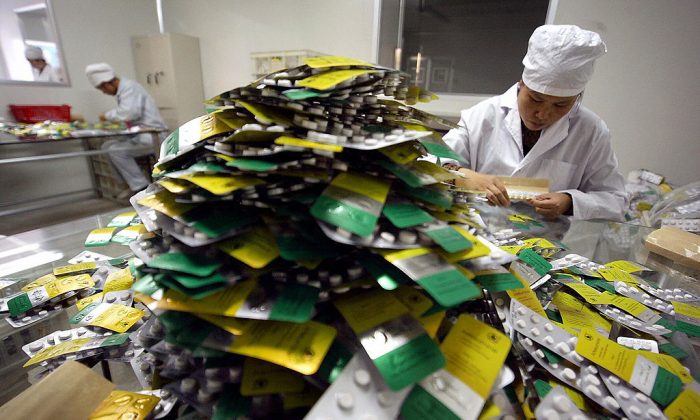 Workers package pills at Guilin Pharmaceutical, in Guilin, southern China's Guangxi province.  (FREDERIC J. BROWN/AFP/Getty Images)