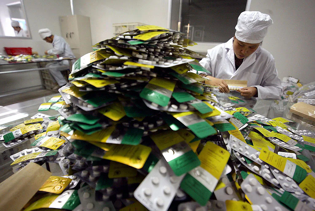 Workers package pills at Guilin Pharmaceutical, in Guilin, southern China's Guangxi province.  (FREDERIC J. BROWN/AFP/Getty Images)