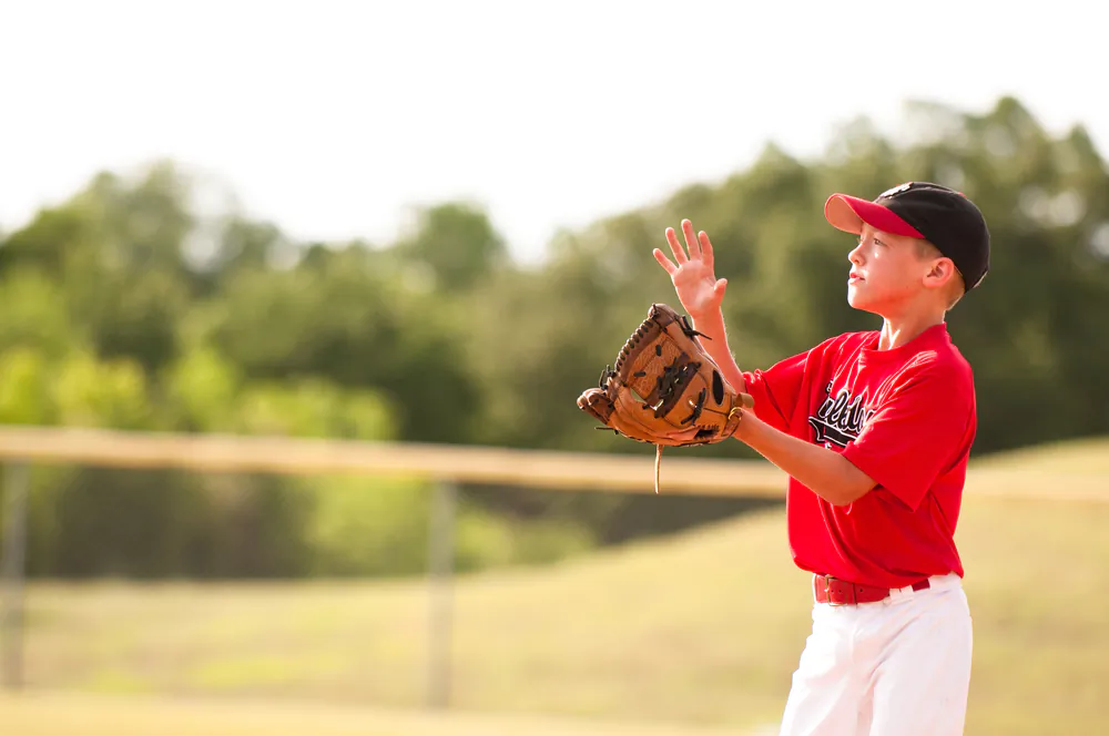 Like many a young boy, once I became old enough I signed up for Little League baseball. (tammykayphoto/shutterstock)