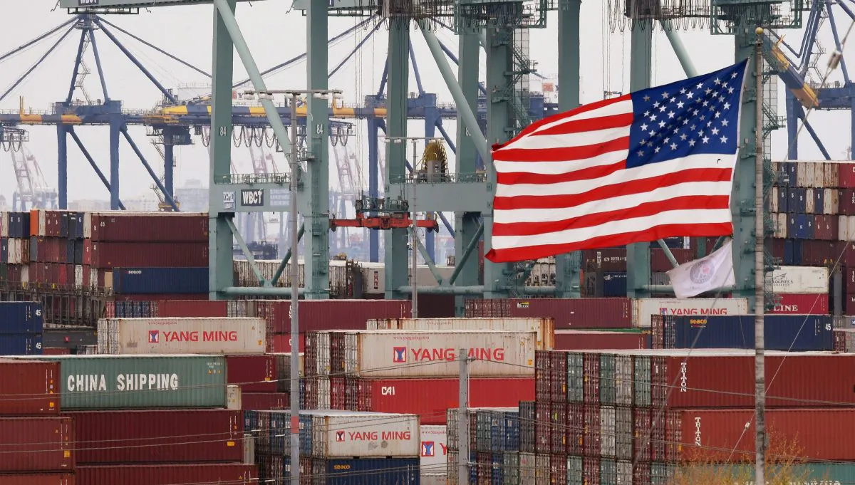 Chinese shipping containers beside a U.S. flag at the Port of Los Angeles in Long Beach, Calif., on May 14, 2019. (Mark Ralston/AFP/Getty Images)