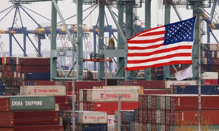 Chinese shipping containers beside a U.S. flag at the Port of Los Angeles in Long Beach, Calif., on May 14, 2019. (Mark Ralston/AFP/Getty Images)