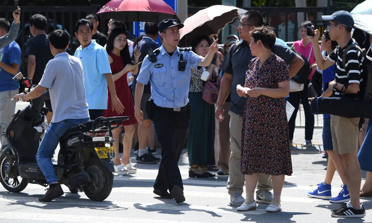 A police officer gesturing to a couple. (Greg Baker/AFP/Getty Images)