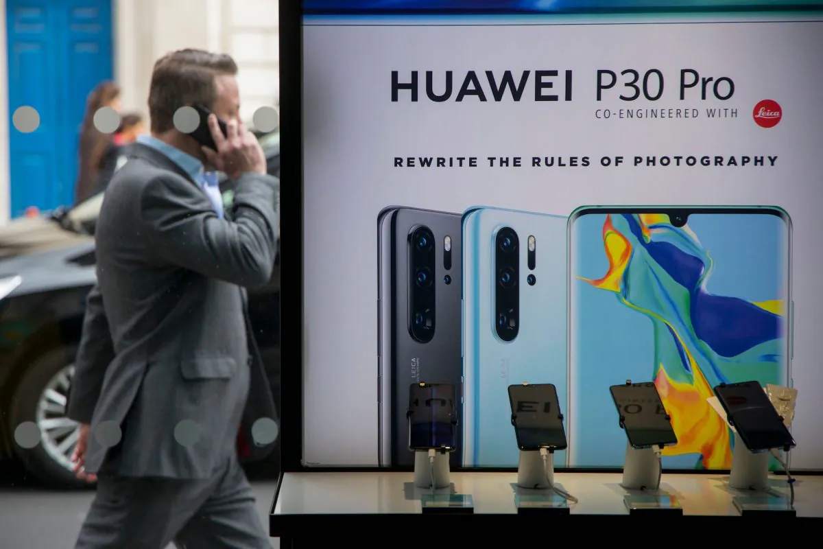 A pedestrian walks past a Huawei product stand in London, on April 29, 2019. (Tolga Akmen/AFP/Getty Images)