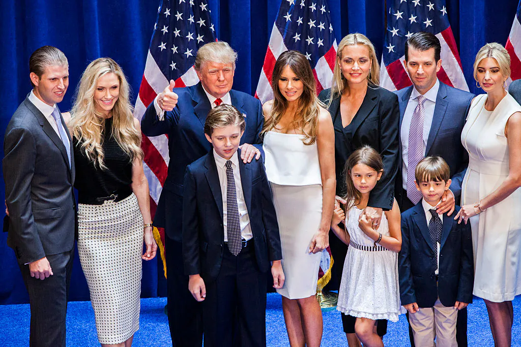 Eric Trump, Lara Yunaska Trump, Donald Trump, Barron Trump, Melania Trump, Vanessa Haydon Trump, Kai Madison Trump, Donald Trump Jr., Donald John Trump III, and Ivanka Trump pose for photos on stage in 2015. (Christopher Gregory/Getty Images)