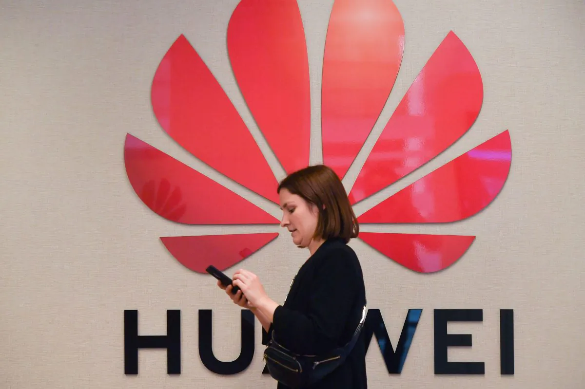 A woman passes by the Huawei logo at the Huawei Cyber Security Transparency Centre in Brussels on May 21, 2019. (Emmanuel Dunand /AFP/Getty Images)
