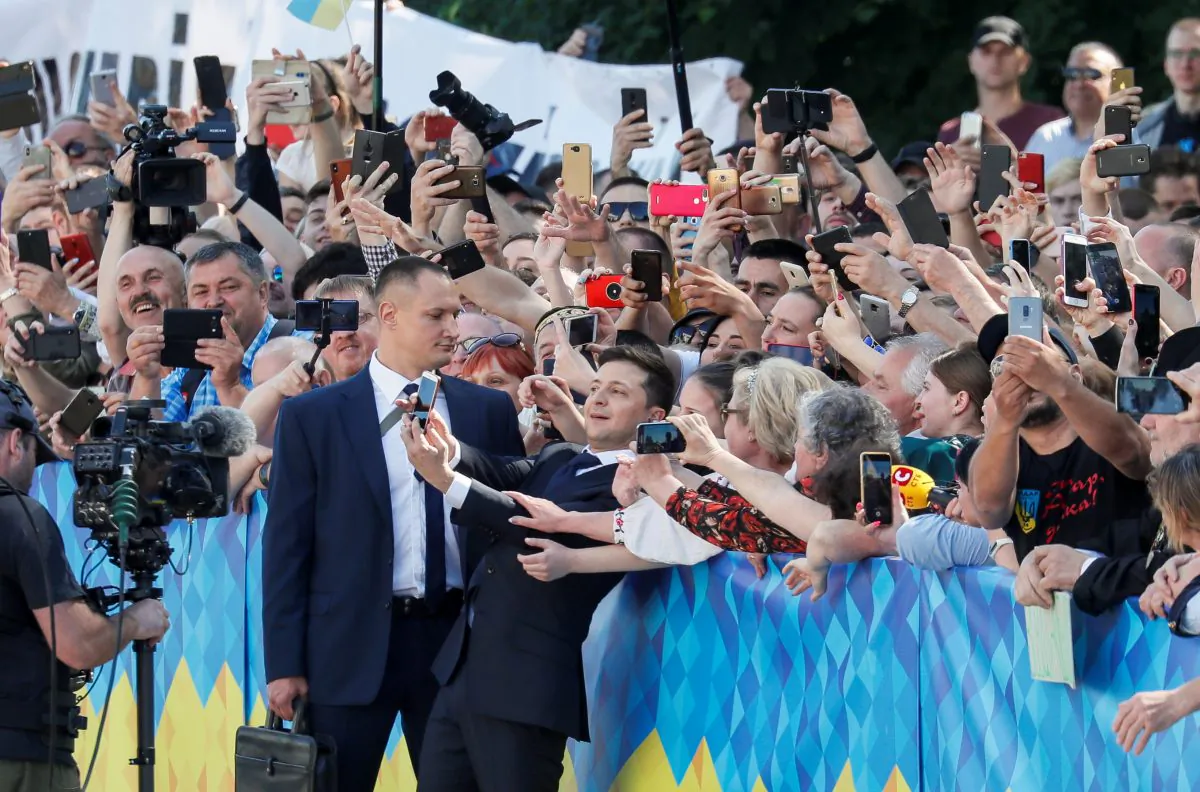 Ukraine's President-elect Volodymyr Zelenskiy takes a selfie with his supporters as he walks to take the oath of office in Kiev, Ukraine on May 20, 2019. (Gleb Garanich/Reuters)