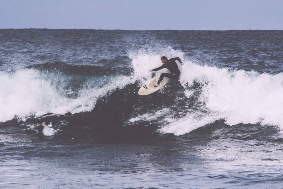 Life can overwhelm you like a set of giant waves. Your best option is to stand up and ride one. (Alec Bennett/Unsplash)