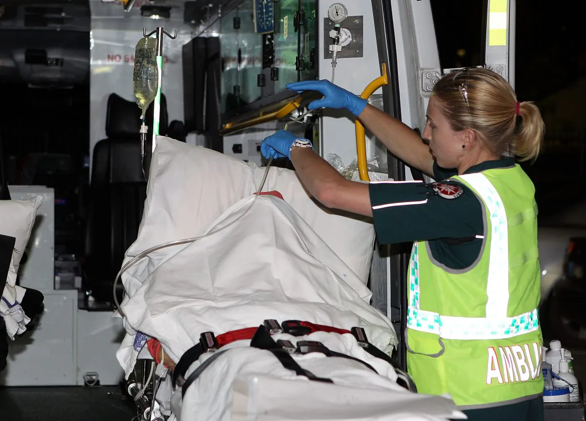 Paramedics load an injured female survivor of the Christmas Island boat wreck into an ambulance after arriving at the Perth Airport in Perth, Australia on Dec. 16, 2010.