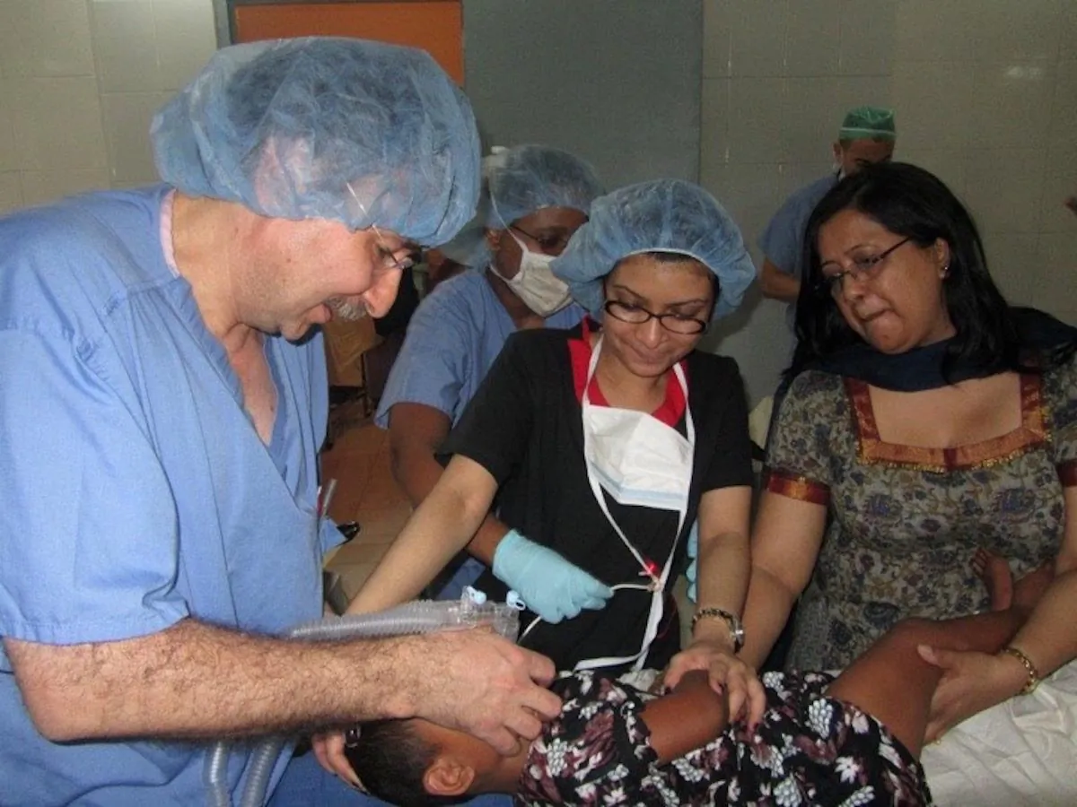 Dr. Shenjuti Chowdhury (C) assisting during surgery. (Courtesy of Dr. Shenjuti Chowdhury)