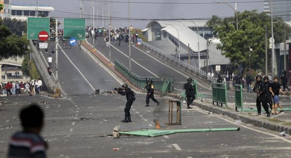 Indonesian police take position during a clash with supporters of Indonesian presidential candidate Prabowo Subianto