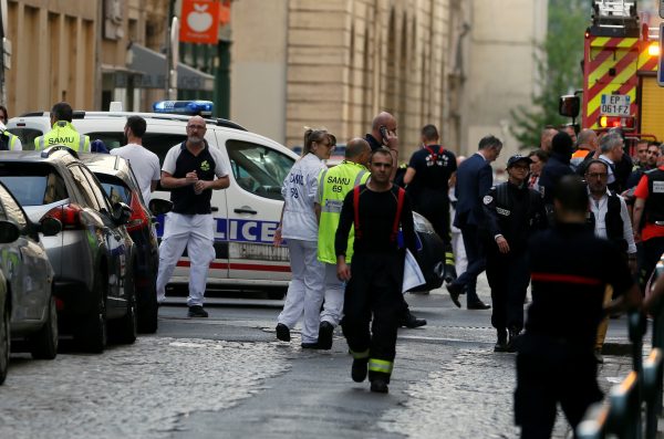 Police officers, fire fighters and medics are seen near the site of a suspected bomb attack in central Lyon