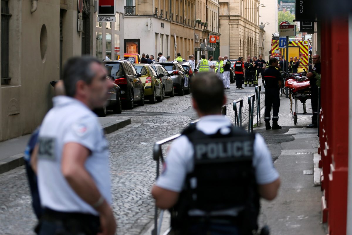 Police officers, fire fighters and medics are seen near the site of a suspected bomb attack in central Lyon