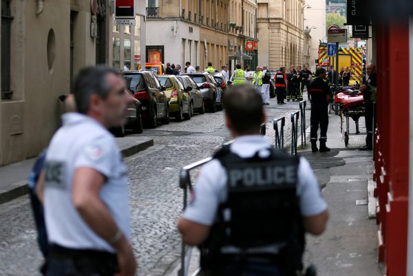 Police officers, fire fighters and medics are seen near the site of a suspected bomb attack in central Lyon