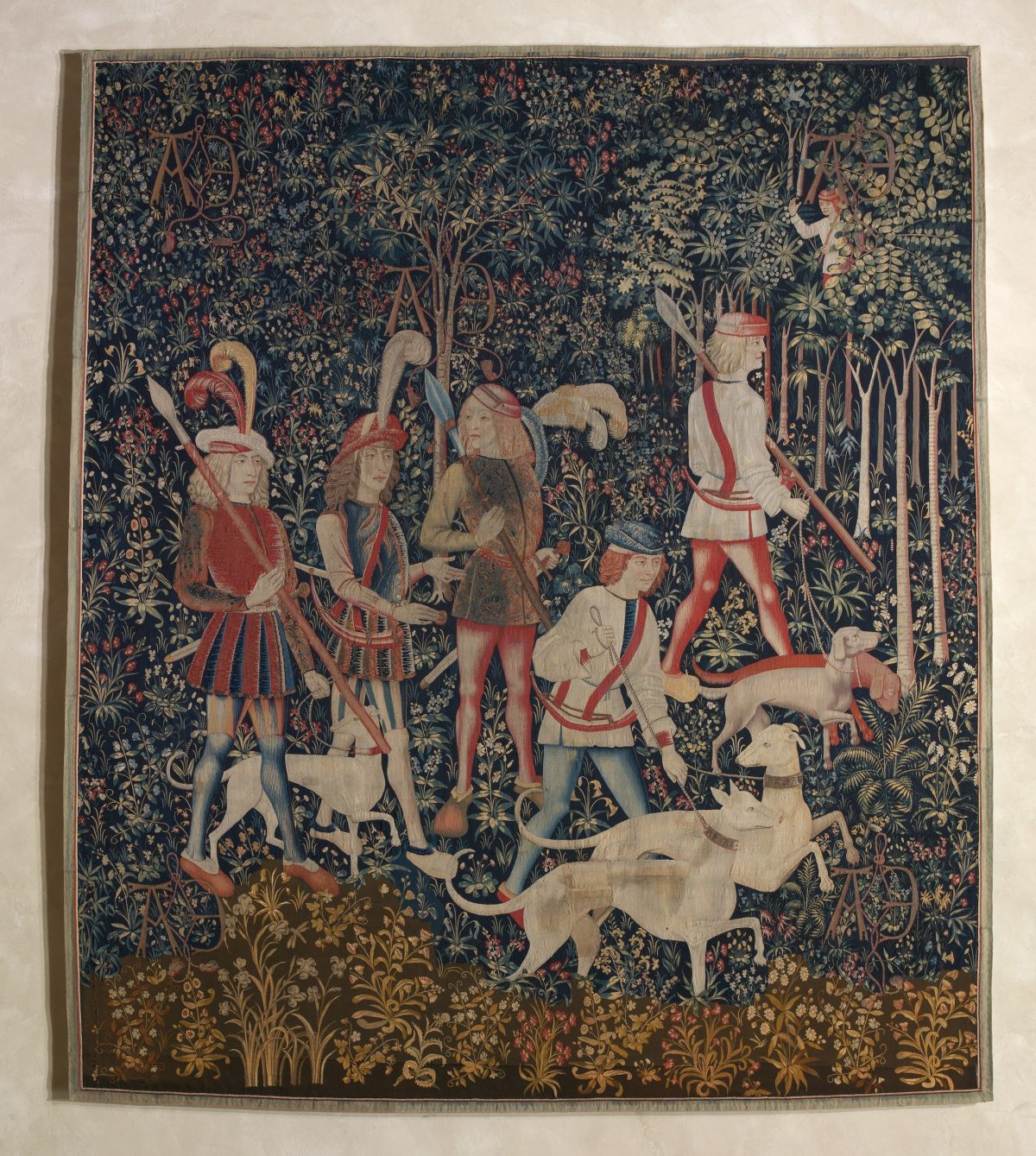 Hunters in woods with hounds
