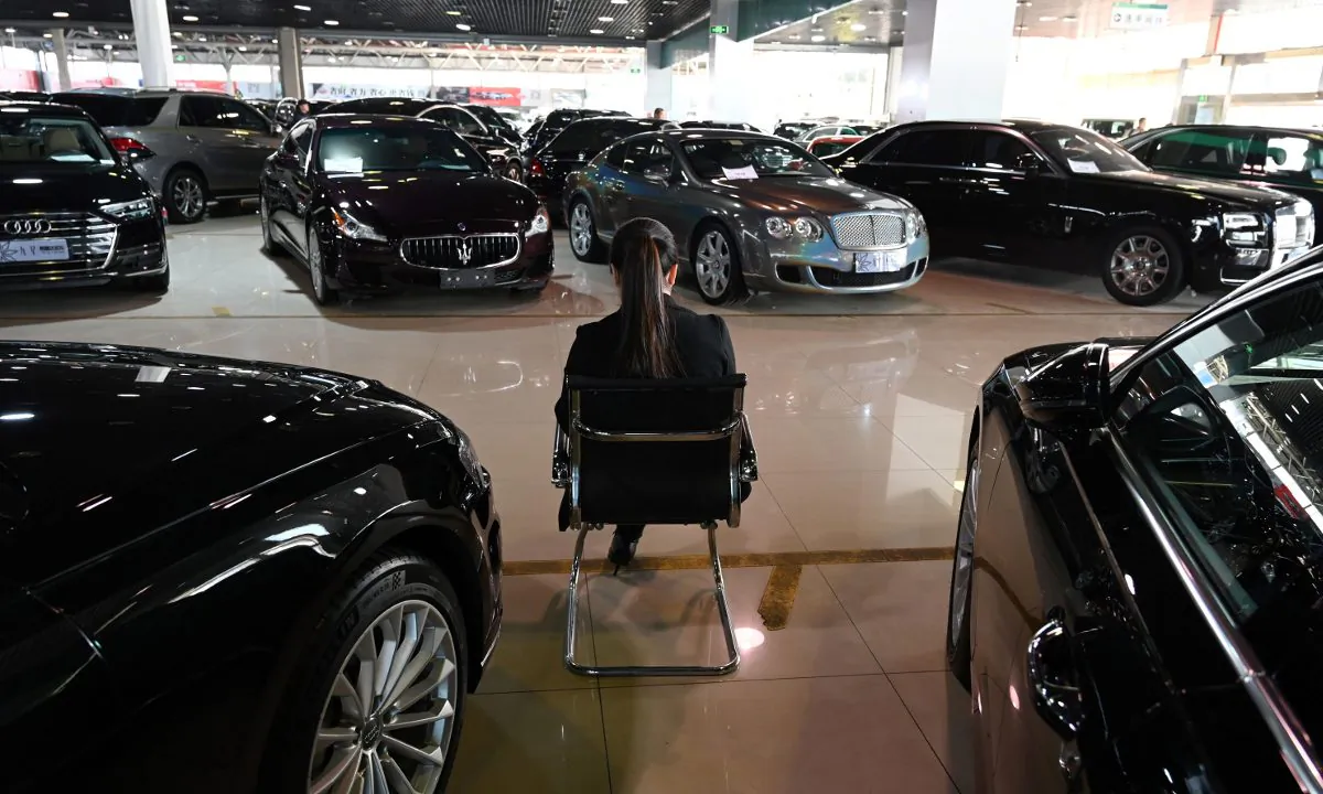 A woman at a car dealership in China. (Greg Baker/AFP/Getty Images)