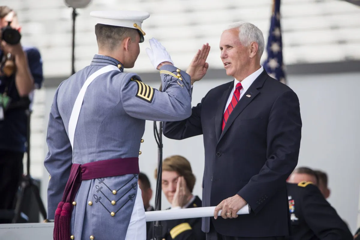 Vice President Mike Pence salutes a graduating cadet before handing him his diploma during graduation ceremonies at the United States Military Academy, in West Point, N.Y., on May 25, 2019. (AP Photo/Julius Constantine Motal)
