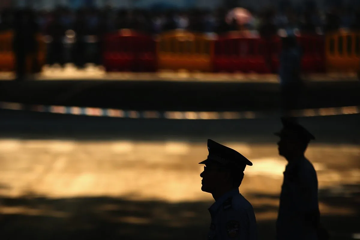 Chinese policemen guard outside the Jinan Intermediate People's Court on August 22, 2013 in Jinan, China. (Feng Li/Getty Images)