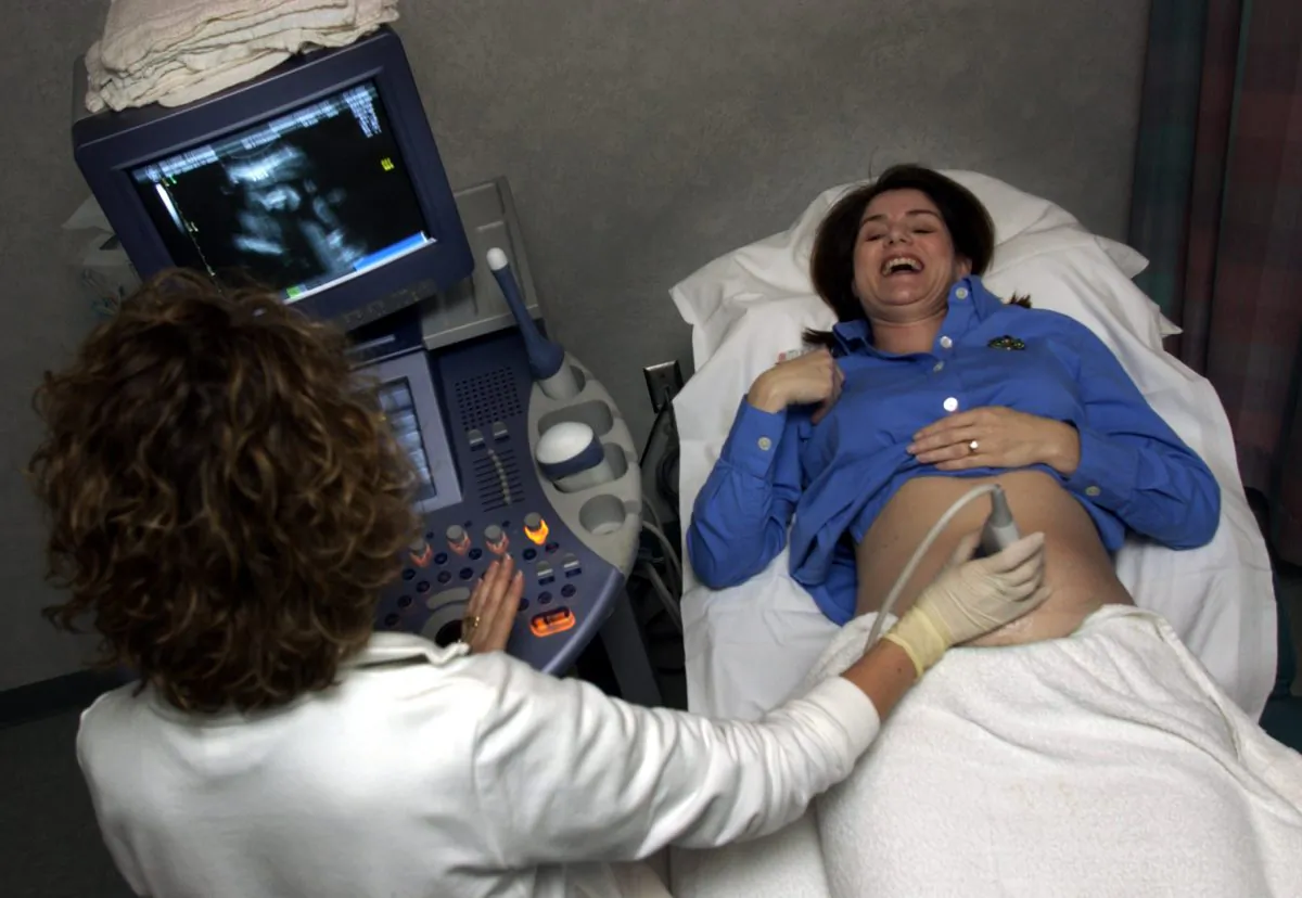 Tamara Nicolle (R) smiles and laughs after hearing and seeing her six-month-old unborn child during an ultrasound at Memorial Hospital January 17, 2003 in Savannah, Georgia. Stephen Morton/Getty Images