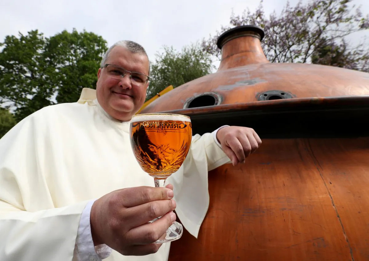 Norbertine Father Karel poses with a Grimbergen beer in the courtyard of the Belgian Abbey of Grimbergen, Belgium. (REUTERS/Yves Herman)