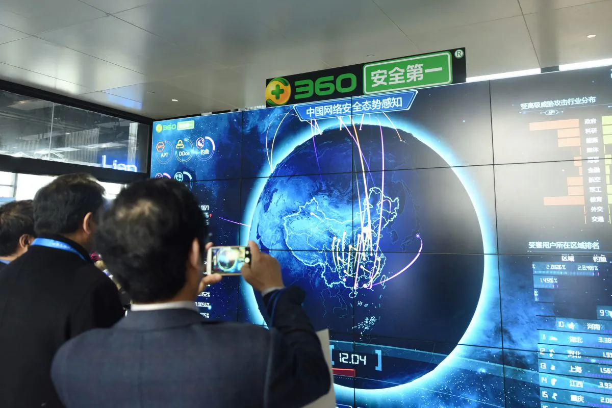 A man taking pictures of internet security data displayed on a screen at the Qihoo booth during the 4th World Internet Conference in Wuzhen, Zhejiang Province, China.
(AFP/Getty Images)