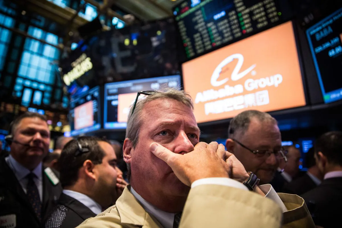 Traders work on the floor of the New York Stock Exchange while the price of Alibaba Group's initial price offering (IPO) is decided in New York City on Sept. 19, 2014. (Andrew Burton/Getty Images)