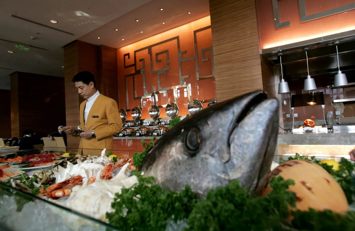 A waiter serves in the coffee bar of an upscale hotel in Beijing, on Feb. 2, 2008. (China Photos/Getty Images)