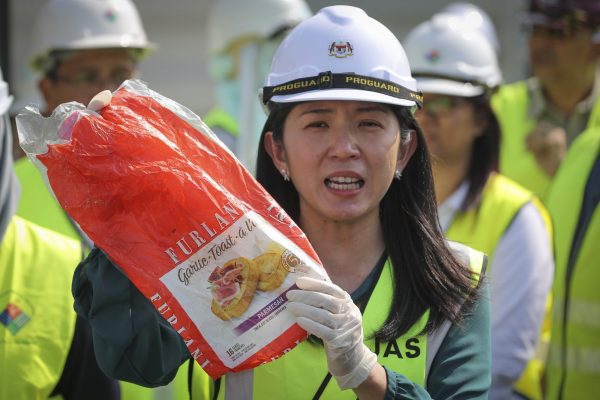 Malaysia's Minister of Energy, Science, Technology, Environment and Climate Change Yeo Bee Yin shows a sample of plastic waste