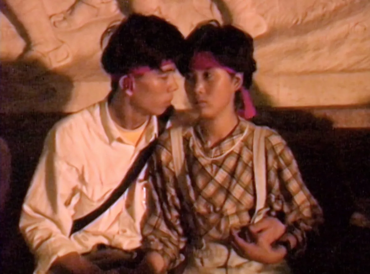 Screenshot of a young couple seated on the top step of the Monument to the People’s Heroes in Beijing on June 4, 1989. Canadian journalist Arthur Kent shot this video around 3 a.m., before the army completely blocked off the east side of Tiananmen Square. (Courtesy Arthur Kent)