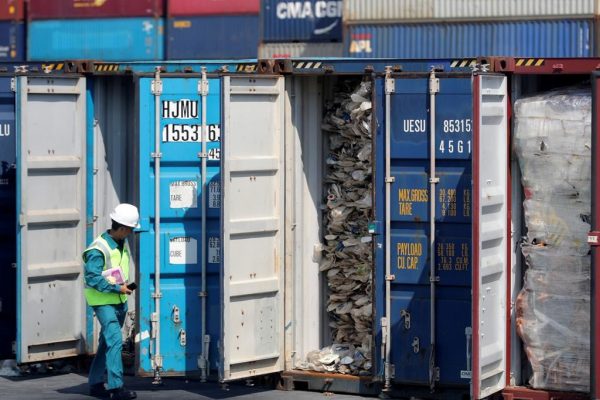 A Malaysian official inspects a container filled with plastic waste shipment prior to sending it to the Westport in Port Klang, Malaysia on May 28, 2019. (Vincent Thian/The Canadian Press/AP)