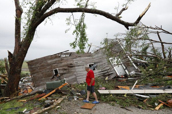 Joe Armison looks over damage to his home