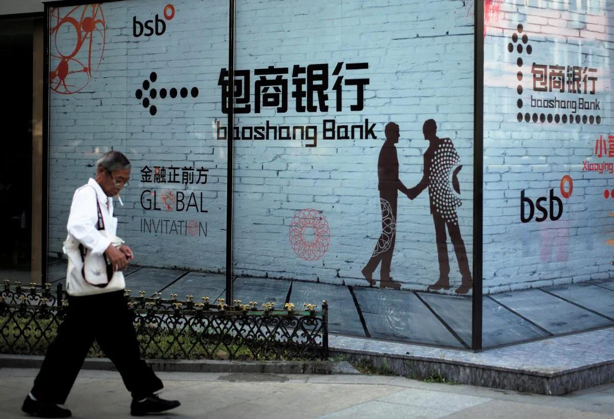 A man walks past a building with an advertisement of Baoshang Bank in Beijing on Sept. 8, 2018. (Reuters)