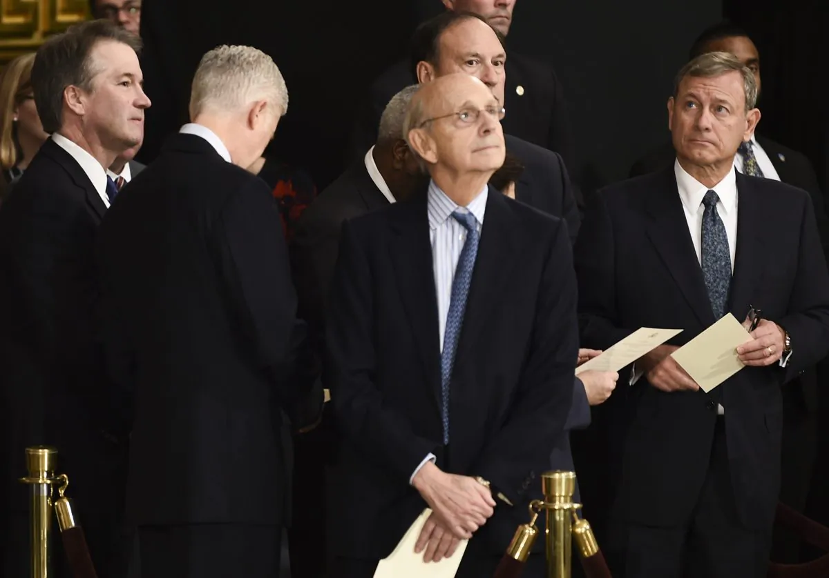 Members of the Supreme Court Brett Kavanaugh (L), Neil Gorsuch (2L), Stephen Breyer, and John Roberts (R) wait for the casket containing the remains of former US President George H.W. Bush to arrive at the U.S Capitol Rotunda on December 03, 2018 in Washington, DC. Brendan Smialowski - Pool/Getty Images