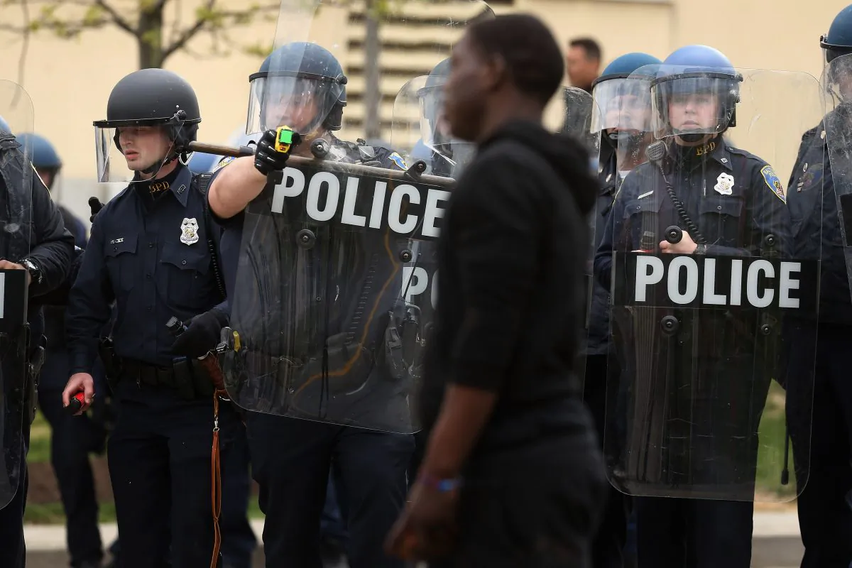 A Baltimore Police officer aims his taser at a demonstrator outside the Mondawmin Mall following the funeral of Freddie Gray in Baltimore, Md., on April 27, 2015. Gray, 25, was arrested for possessing a switch blade knife on April 12 outside the Gilmor Homes housing project on Baltimore's west side.  Chip Somodevilla/Getty Images