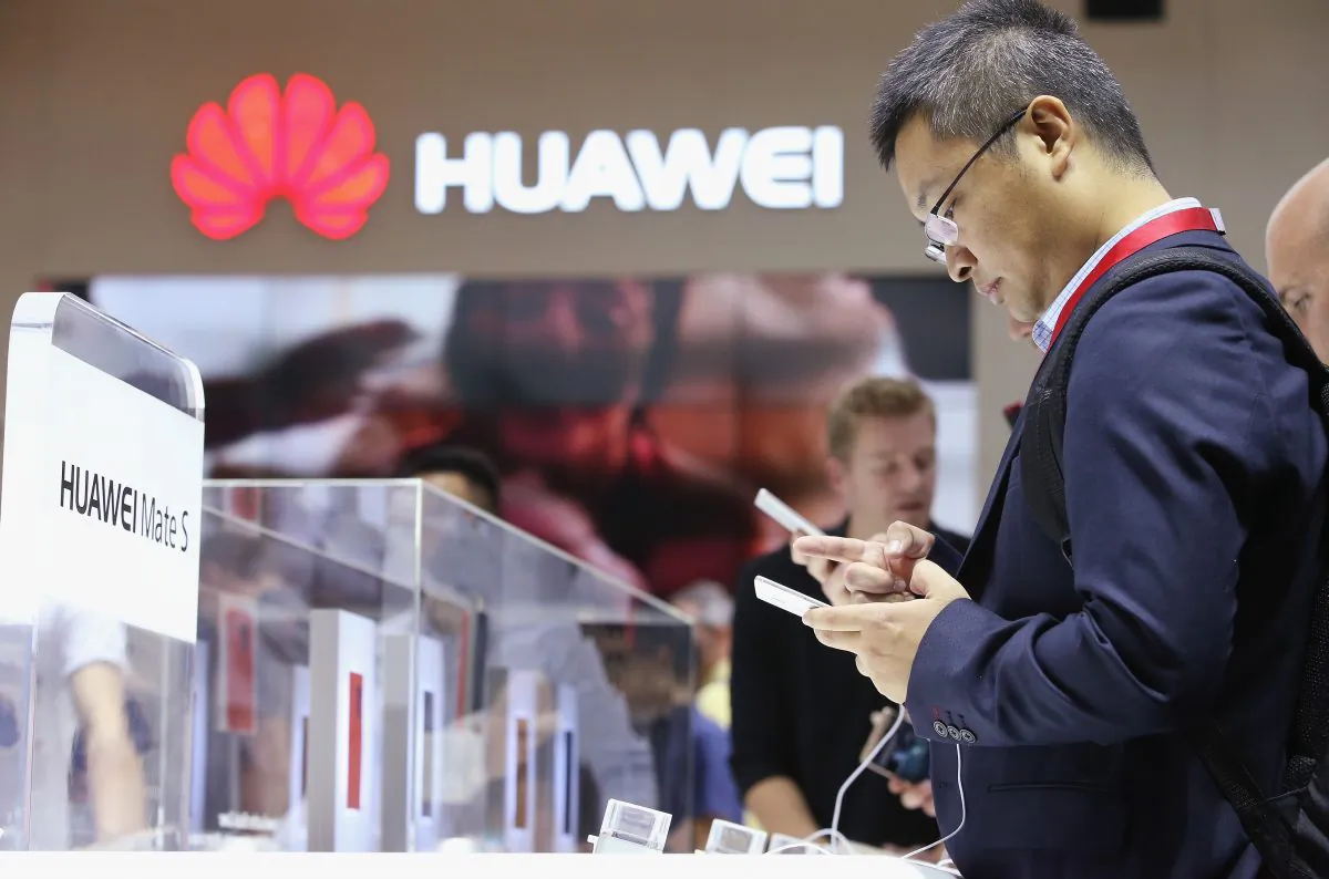 Visitors try out the Huawei Mate S smartphone at the Huawei stand at the 2015 IFA consumer electronics and appliances trade fair on September 4, 2015 in Berlin, Germany. (Sean Gallup/Getty Images)