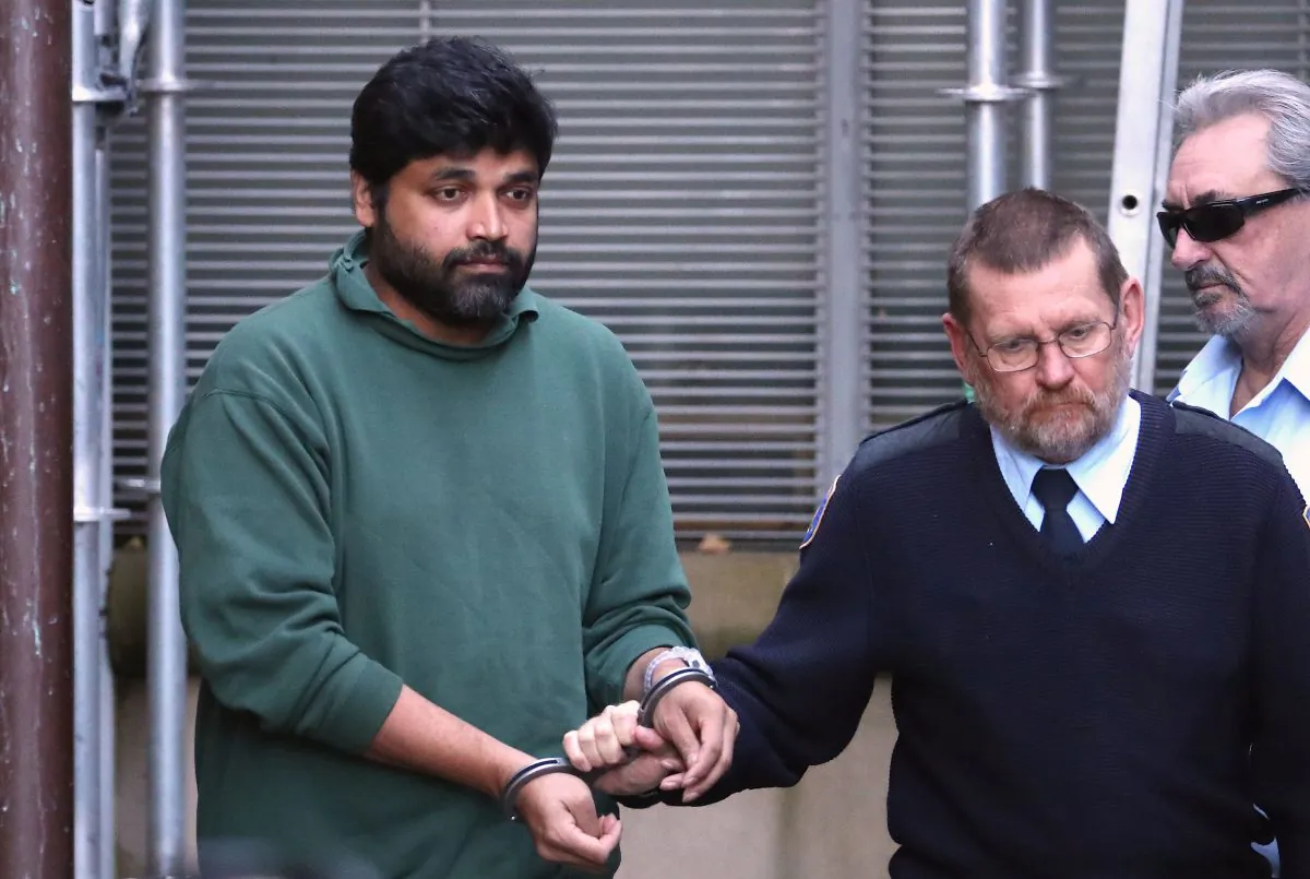 Shahab Ahmed (left) is taken from the NSW Supreme Court in Sydney, Australia, on May 30, 2019. (AAP Image/David Gray) NO ARCHIVING