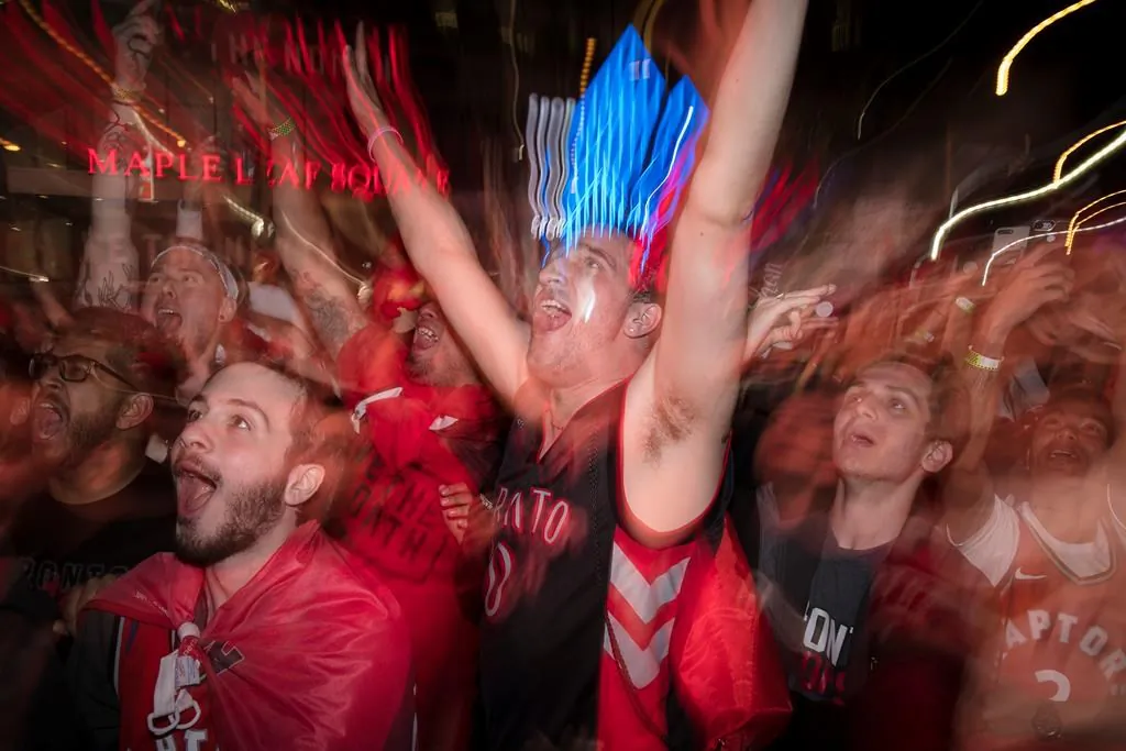 Toronto Raptors fans celebrate outside the Scotiabank Arena at what's dubbed "Jurassic Park," at the end of their teams NBA finals debut against the Golden State Warriors, winning 118-109, in Toronto on May 30, 2019. (Tijana Martin/The Canadian Press)
