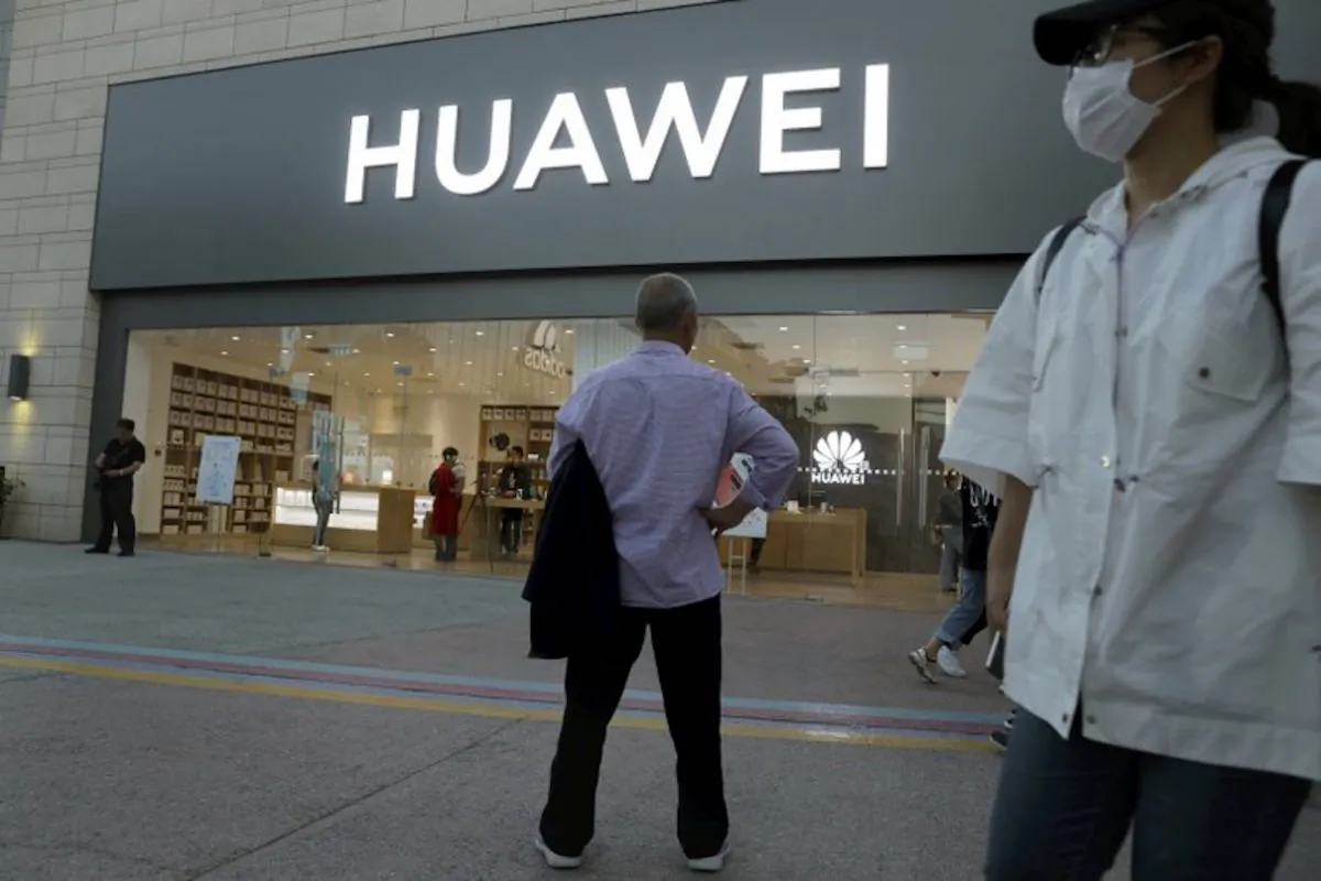 A man stands outside a Huawei store in Beijing on May 20, 2019. (Ng Han Guan/AP)