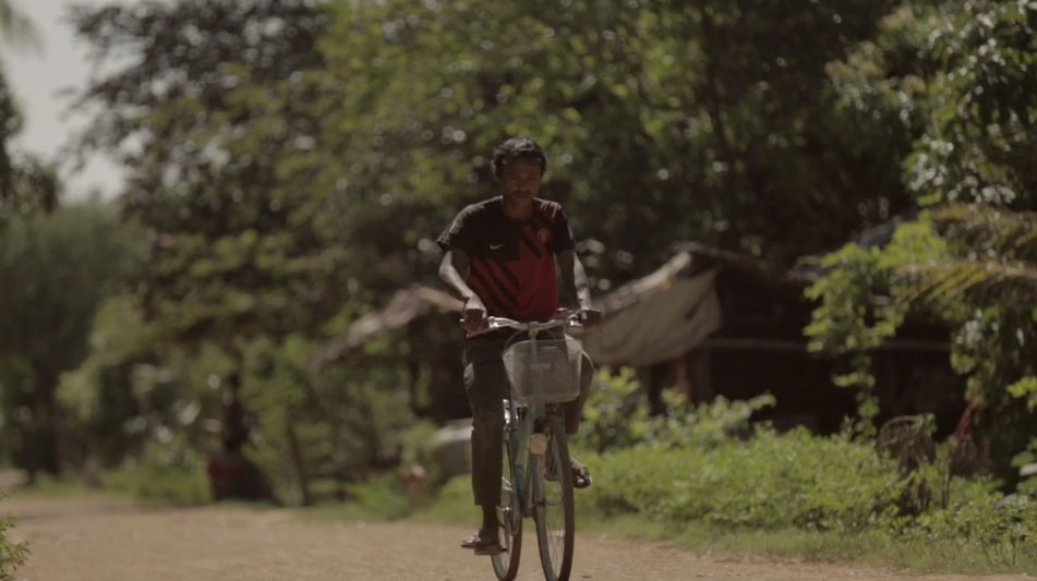 former Thai slave on bicycle