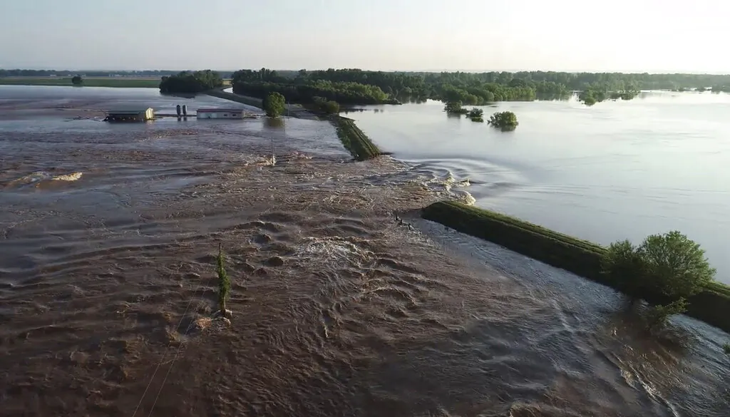 In this aerial image provided by Yell County Sheriff's Department water rushes through the levee along Arkansas River in Dardanelle, Ark., on May 31, 2019. (Yell County Sheriff's Department via AP) 
