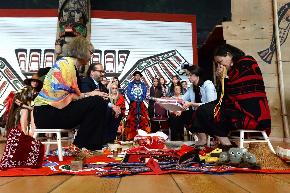 Chief commissioner Marion Buller, left to right, and commissioners Brian Eyolfson, Qajaq Robinson and Michele Audette prepare the final report to give to the government at the closing ceremony for the National Inquiry into Missing and Murdered Indigenous Women and Girls in Gatineau, Que., on June 3, 2019. (Adrian Wyld/The Canadian Press)